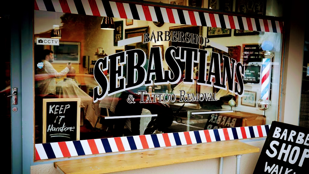 Sebastian's Barbershop storefront window with the hand-lettered sign
