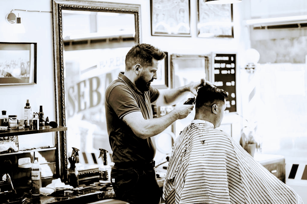 Sebastian working at the barber chair